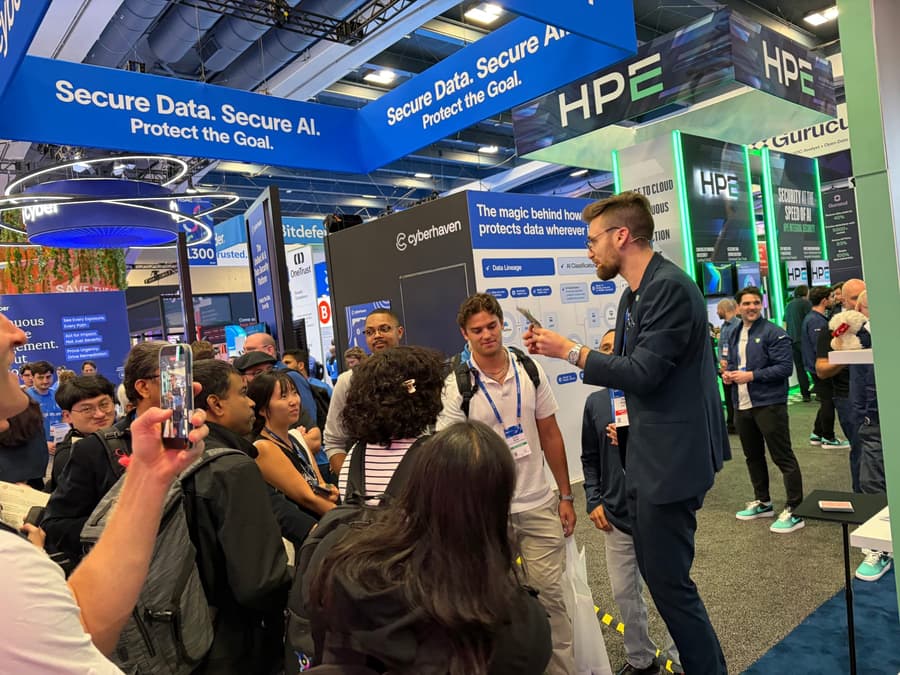 Attendees gathered at a technology booth